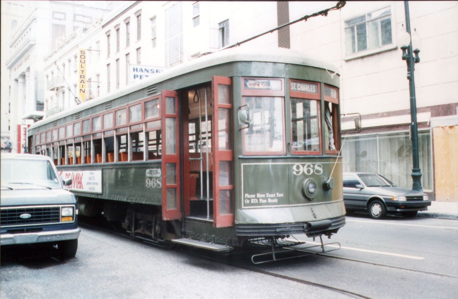 A green New Orleans streetcar on St. Charles Avenue